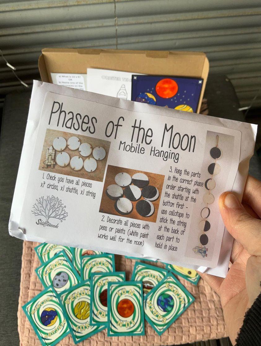 Phases of the moon instructions. A space-themed activity box brimming with captivating resources. Inside the box, you'll find a snap game featuring stunning images of galaxies, planets, and astronauts. Additionally, there are various board games designed to ignite curiosity about space exploration, allowing children to learn about celestial bodies and space missions through engaging play. The box also includes a mobile enabling children to visualize. With its interactive and educational contents, this space box offers an immersive experience, fostering a sense of wonder and discovery about the vast wonders of the universe.