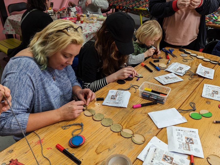 Parent, teen and child decorate moon phases from our kit