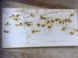 Wooden time zone map with cities burnt in 