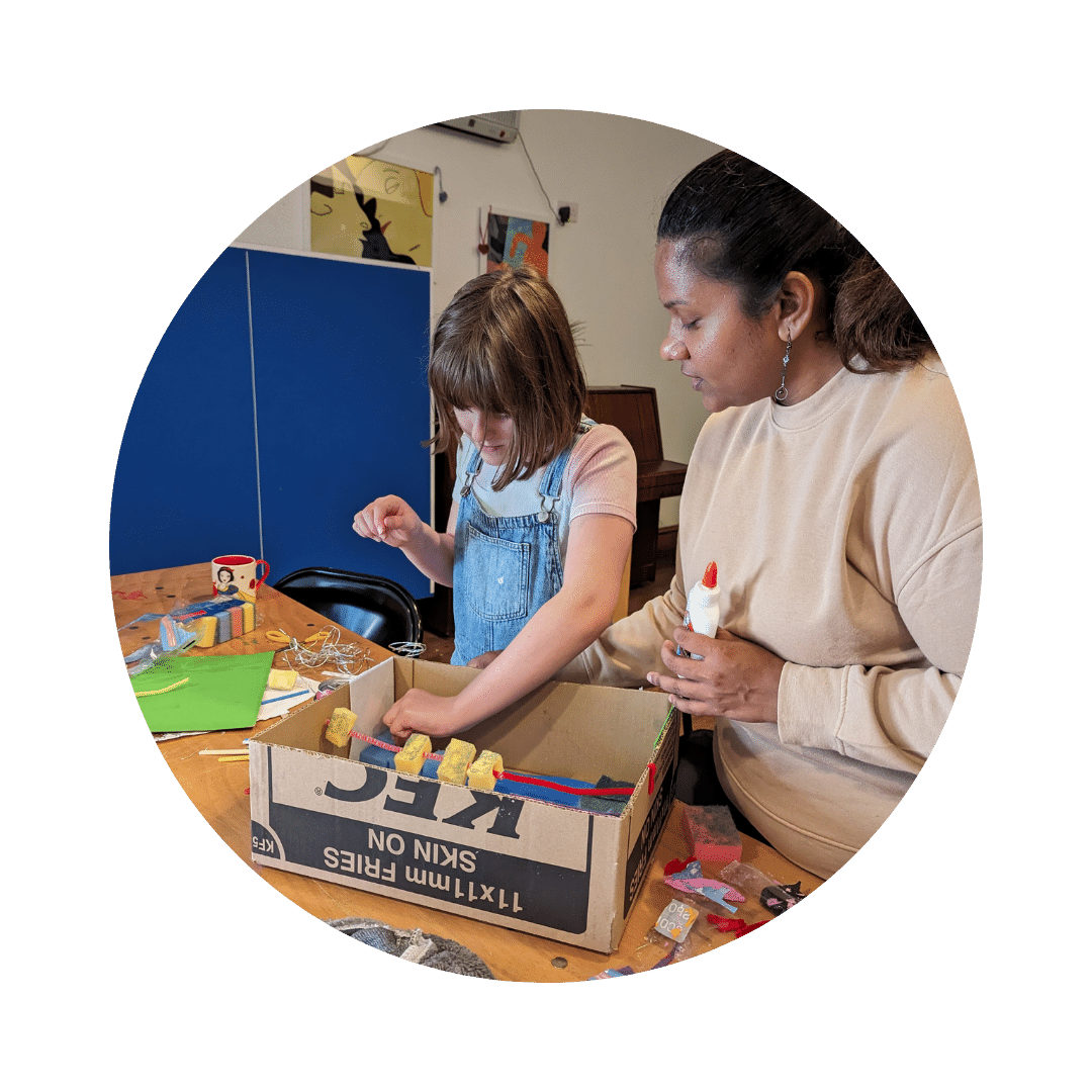 Yakshitha and teen work on a cardboard classroom design