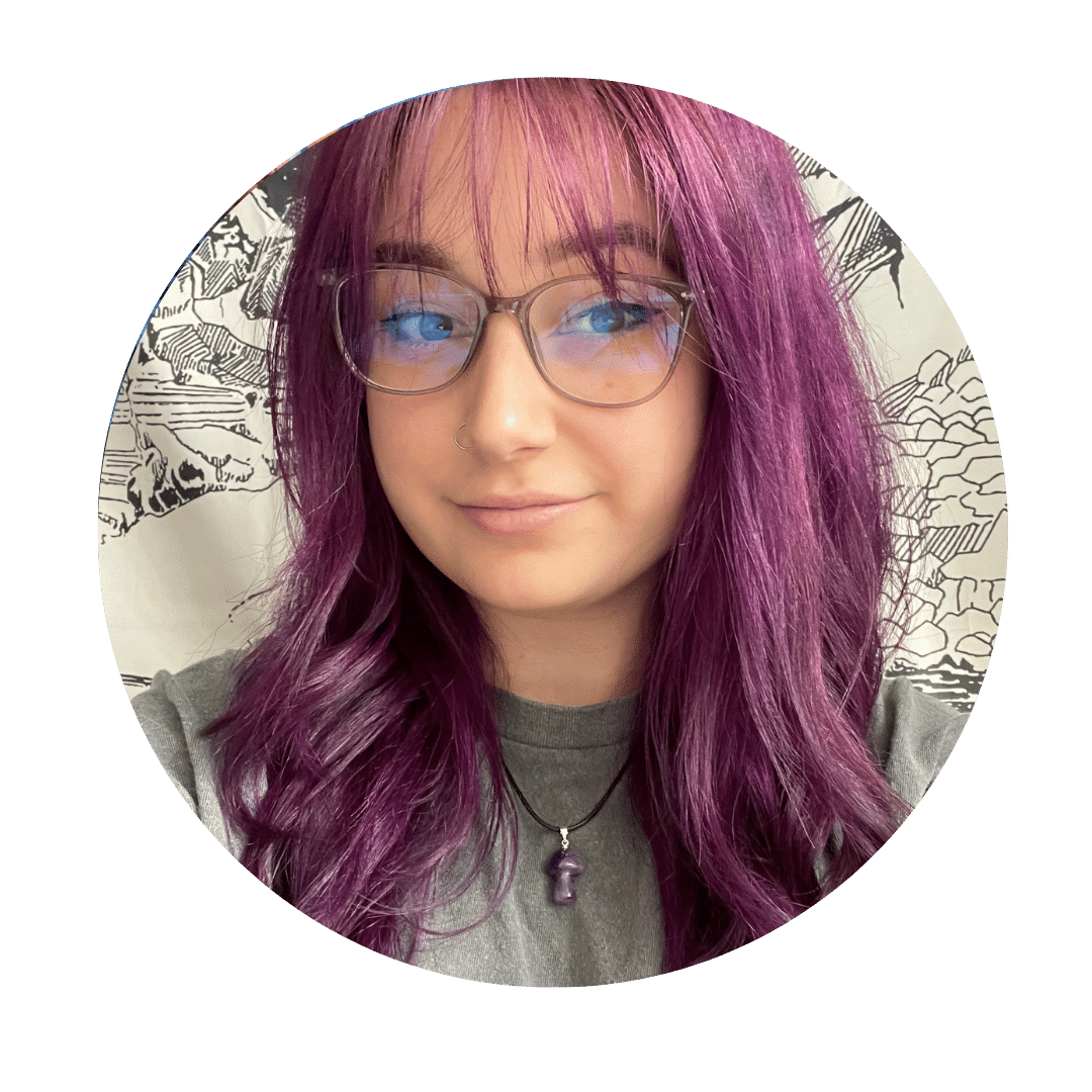 Picture of Hannah who is wearing glasses and has pink hair