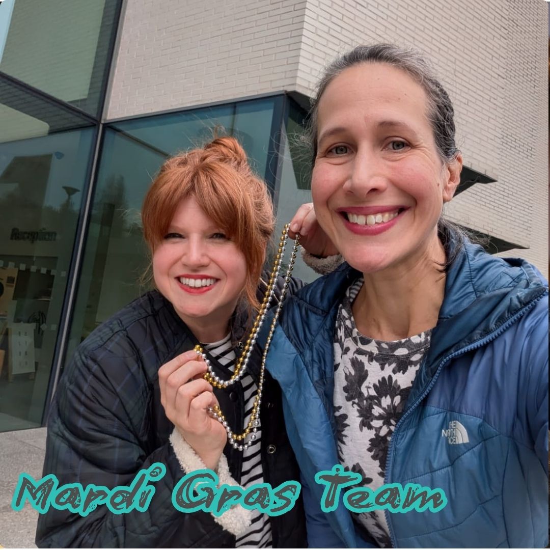 Drs Diana and Andrea hold up Mardi Gras beads