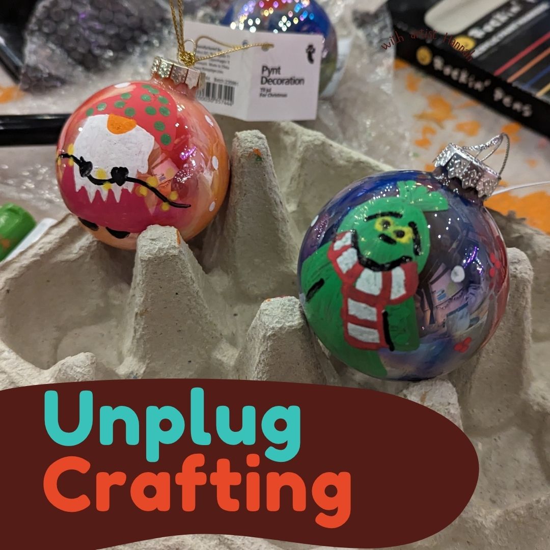 2 painted baubles One looks like the grinch