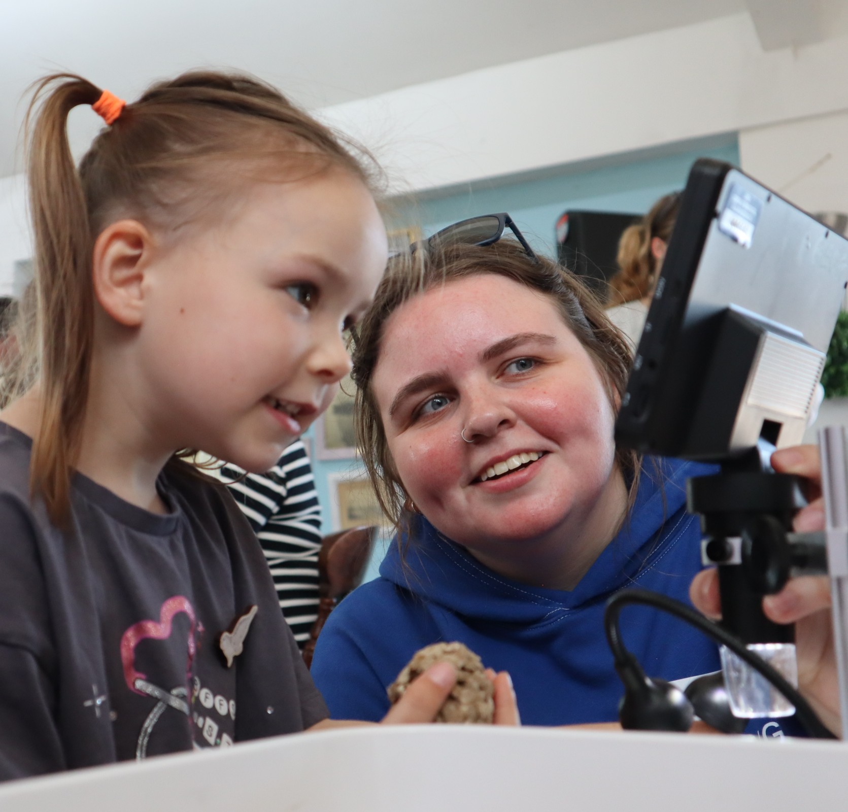 Woman and child looking at a microscope